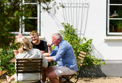 A family is enjoying coffee in the mill garden