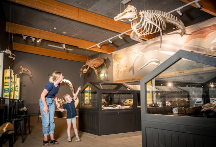 A woman and her daughter are walking through the exhibition